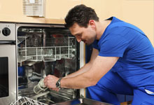 Technician installing a new dish washer